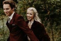 a neutral wedding dress with a high neckline, a burgundy faux fur jacket and an embellished headpiece for a Christmas wedding