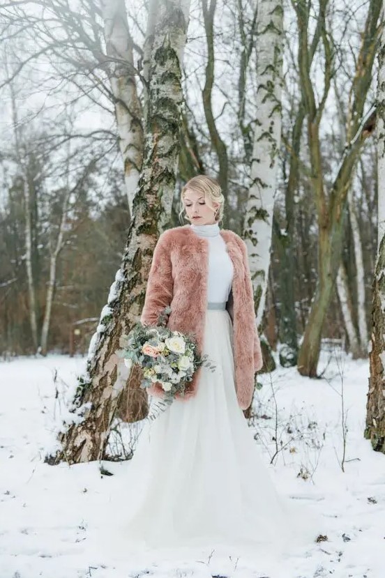 a peach-colored teddy coat is a gorgeous way to add color to your look and stand out in the snow