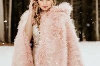 a pink faux fur cover up with a hood will turn your bridal look in a magical and fairy-tale like one adding a subtle touch of color