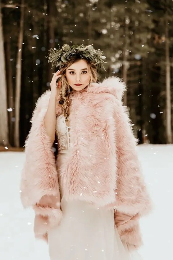 a pink faux fur cover up with a hood will turn your bridal look in a magical and fairy-tale like one adding a subtle touch of color