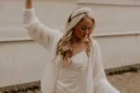 a romantic and cute look with a plain spaghetti strap wedding dress, a semi-sheer cardigan on top and a headband