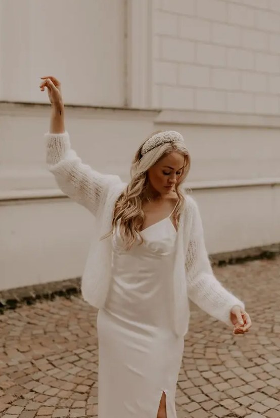 a romantic and cute look with a plain spaghetti strap wedding dress, a semi-sheer cardigan on top and a headband