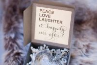 a silver heart ornament in a box is a cute and chic winter or holiday wedding favor