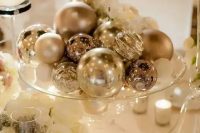a silver ornaments will be an easy, budget-friendly and glam centerpiece is a cool idea for a winter wedding