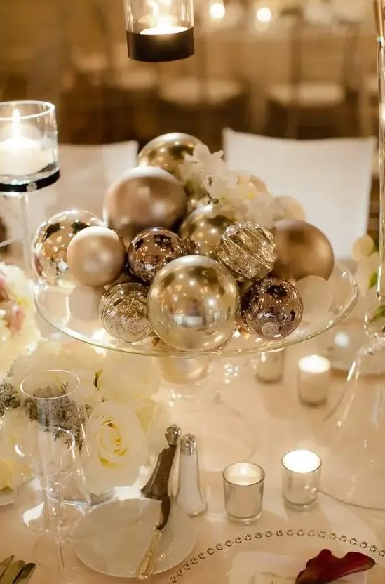 a silver ornaments will be an easy, budget-friendly and glam centerpiece is a cool idea for a winter wedding