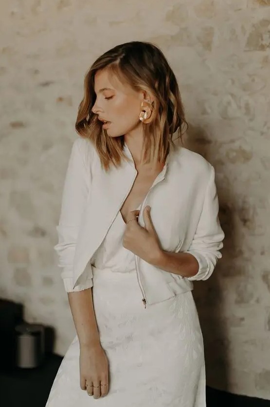 a simple and minimalist plain cropped bridal jacket with a zip and cropped sleeves is a chic addition to the look