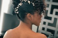 a sophisticated curly updo with curls on top and a pearl hair vine accenting the face