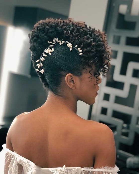 a sophisticated curly updo with curls on top and a pearl hair vine accenting the face