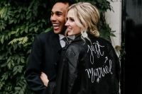 a stylish black leather hand painted jacket is a great cover up for a wedding, it looks very contrasting with a neutral wedding dress