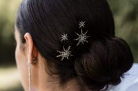 a twisted low fun with a sleek yet voluminous top and celestial hair pins is amazing to rock