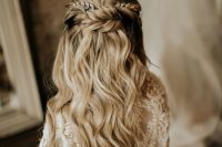 a wedding half updo with a bump on top and a twisted halo, waves down and rhinestone hairpieces is very chic