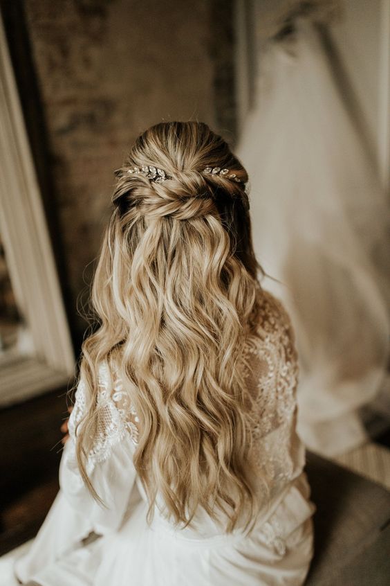 a wedding half updo with a bump on top and a twisted halo, waves down and rhinestone hairpieces is very chic