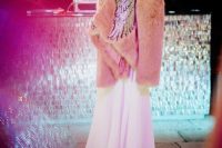 a whimsical pink faux fur coat with embroidred iridescent angel wings is a fantastic and breathtaking piece to wear