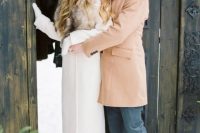 a white coat with a luxurious fur collar will add a refined touch and a chic feel to your bridal look