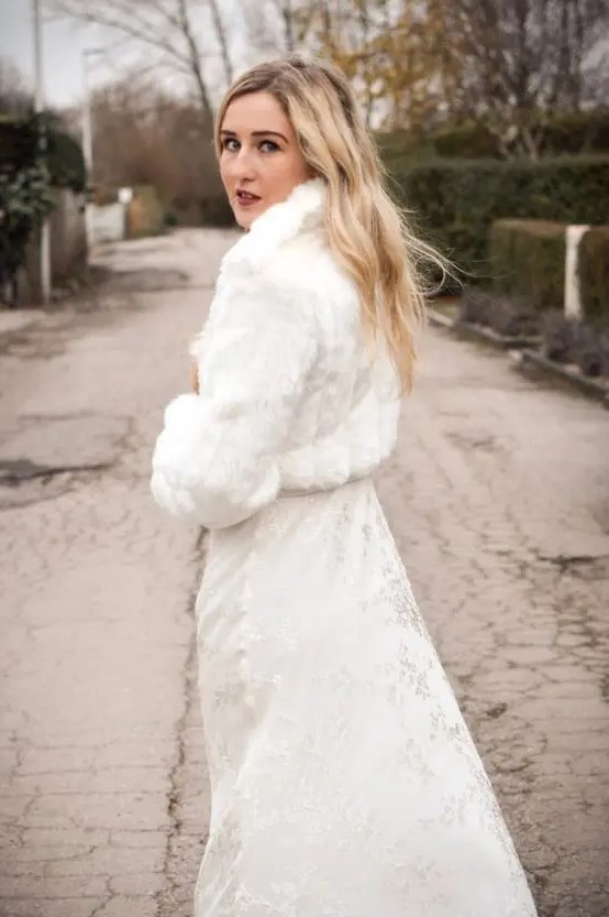 a white faux fur cropped bridal jacket is a great and timeless cover up for a modern bride