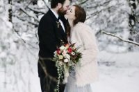 a white fuzzy fur coat over a grey embellished wedding dress is a trendy and chic idea to keep you warm