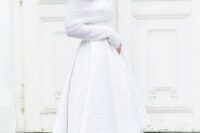 a white high low textural skirt with a train and a chunky off the shoulder sweater with long sleeves