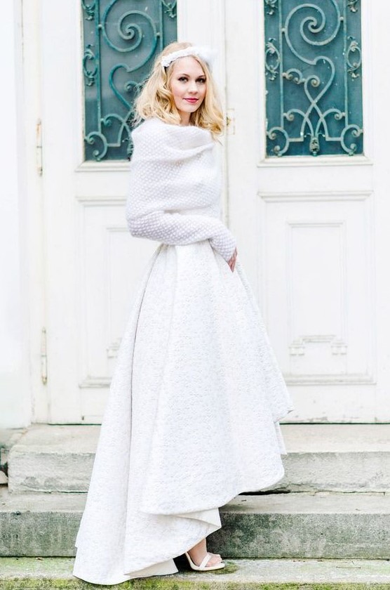 a white high low textural skirt with a train and a chunky off the shoulder sweater with long sleeves
