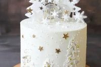 a white winter wedding cake with frosting trees and edible beads as ornaments, sugar trees with stars and clear pops