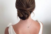 a woven low bun with a bump on top is a stylish and elegant idea for many bridla looks, in winter and not only
