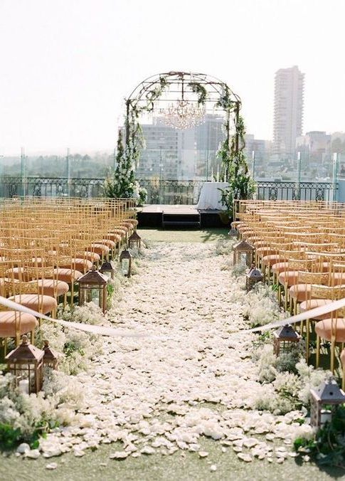 rooftop wedding aisle with petals and lanterns