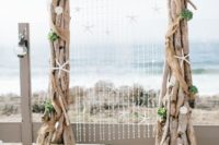 04 large driftwood wedding arch decorated with shells and star fish