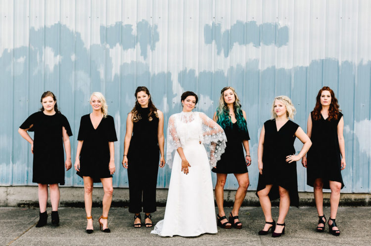 The bridesmaids were wearing black to make the bride in her ivory dress stand out