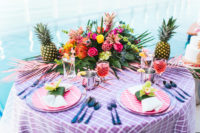 05 The sweetheart table was decorated in super bold tropical colors, with tropical flowers and palm leaves and pineapples for decor