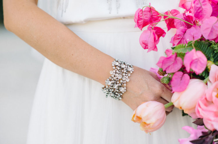A gorgeous bracelet echoes with the embellishments on the dress