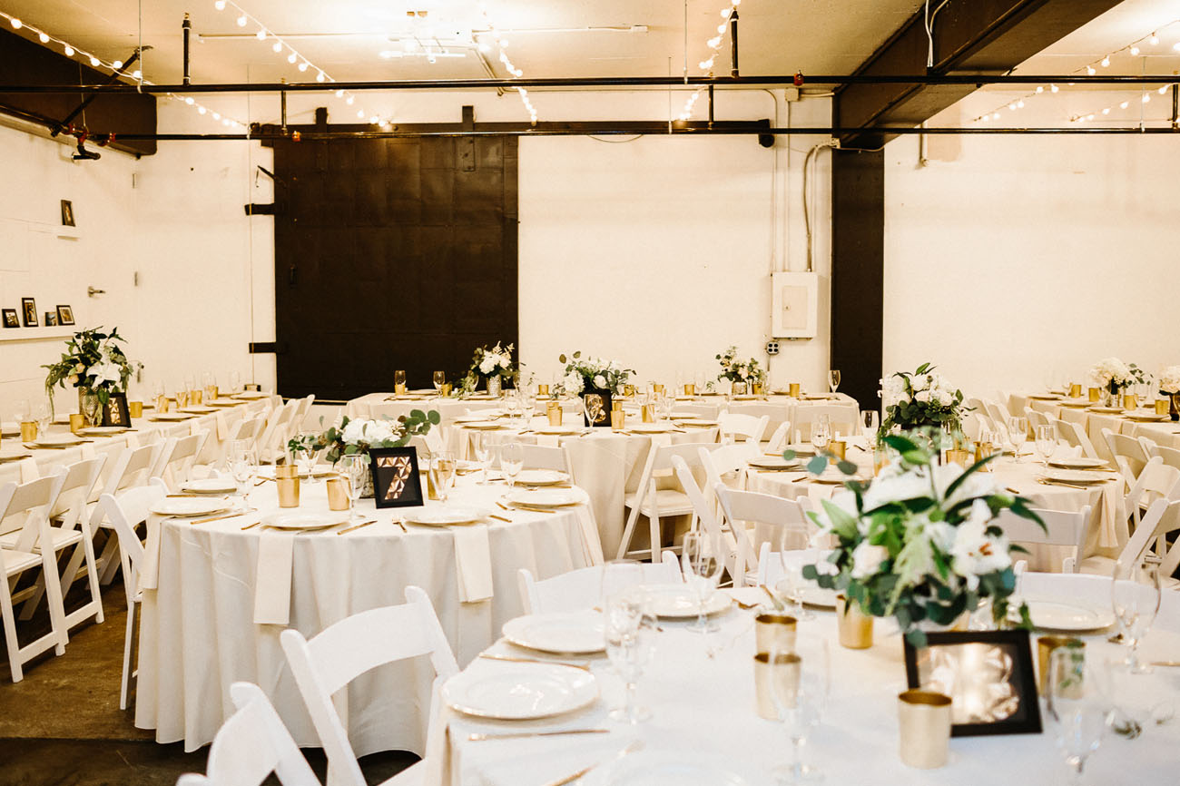 The venue was decorated simple, in black and white, with greenery and flower centerpieces