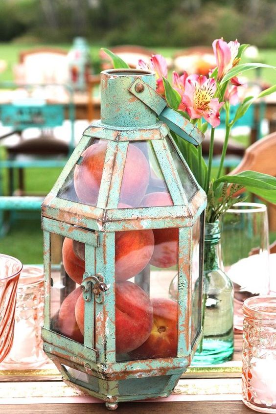 antique patina lantern with real peaches inside as a centerpiece