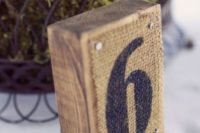 10 wood pieces with table numbers on burlap