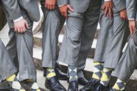 11 light grey suits, yellow and grey socks for the groomsmen
