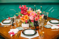 12 Black glasses, gilded tableware, geometric candle holders and super bold flowers comprised a cool table setting