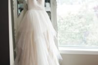 12 gorgeous bridal dress hung on a vintage mirror