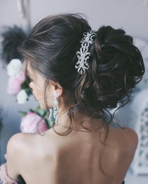 messy updo for long hair with a crystal hairpiece