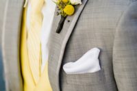 12 pair a lemon yellow waistcoat and boutonniere with a soft grey suit for a sophisticated yet modern groom’s outfit