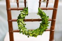 13 little evergreen wreaths with cream ribbon will elegantly hint on the holidays