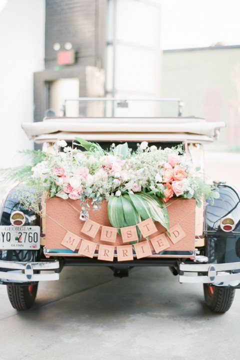 peach colored car decor with greenery and peach flowers