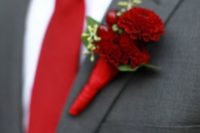16 a crimson red tie and dahlia boutonniere with a dark grey suit