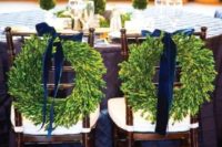 16 wreath with velvet bows that mark the newlyweds’ seats