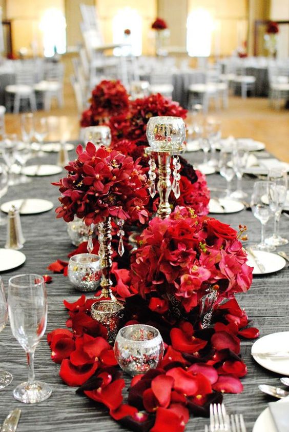 grey tablecloth and a lush bold red floral table runner