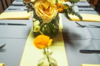 18 dove grey tablecloth, a yellow table runner and yellow floral centerpieces