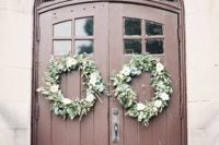 19 winter wedding wreaths with flowers on the venue doors