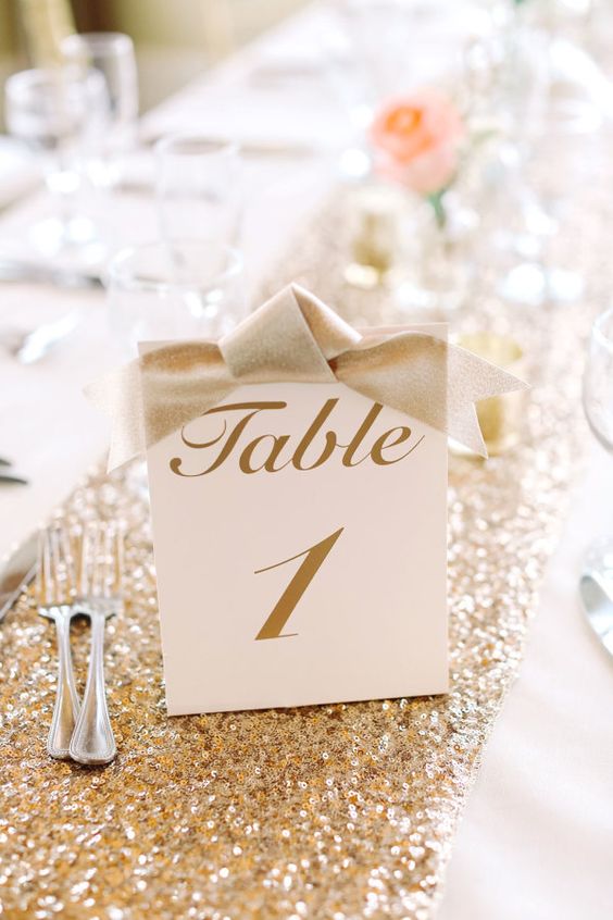 gold calligraphy table numbers with bows
