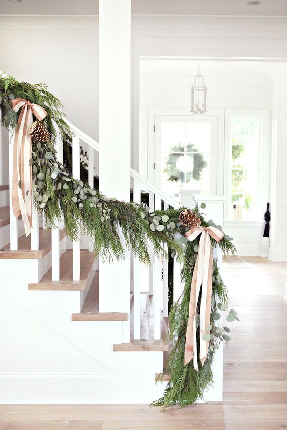 lush evergreen garland with pinecones and silk bows for wedding decor