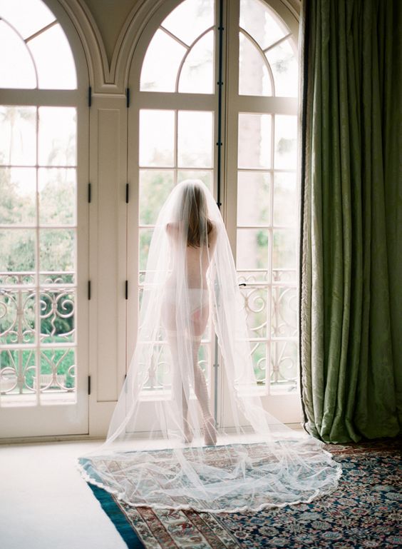 boudoir-styled picture with lingerie, shoes and a veil