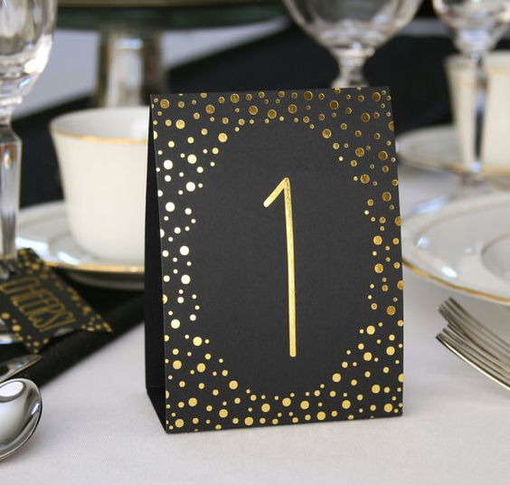 gold and black tented table cards with numbers