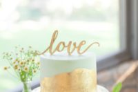 23 one-tier mint wedding cake with gold leaf and a cake topper