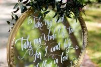 23 round mirror sign with greenery and flowers